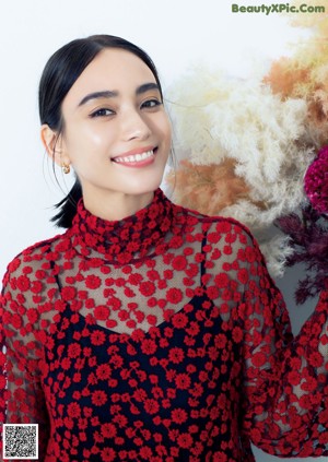 A woman holding a bunch of flowers in her hand.