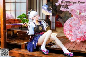 A woman sitting on a wooden bench holding a cell phone.