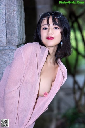 A woman sitting on top of a wooden bench.