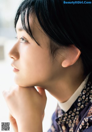 A woman leaning on the railing of a staircase.