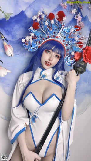 A woman in a blue and white outfit holding a sword.