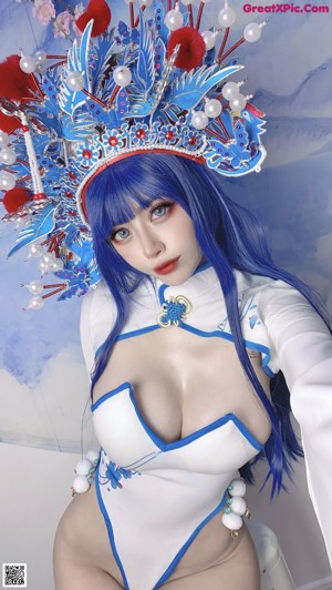 A woman in a white and blue costume posing for a picture.